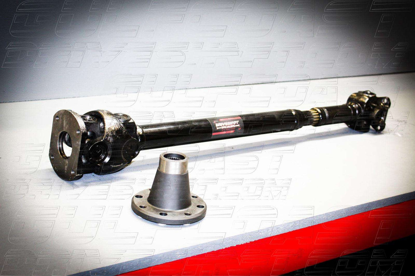 Front and rear 1350 series driveshaft for 2007-2018 Jeep JK 4-door, featuring solid U-joints and accessories. Black metal construction.