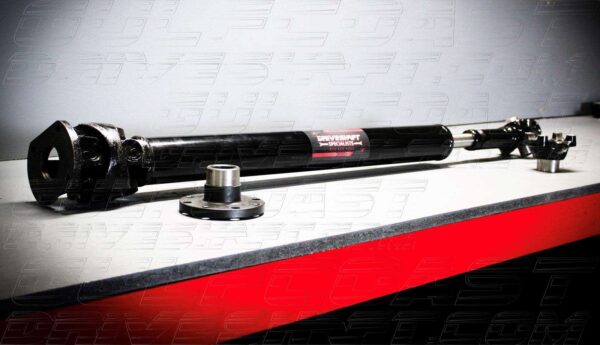 Front and rear 1350 series driveshaft for 2007-2018 Jeep JK 4-door models, featuring black tubing and solid U-joints.
