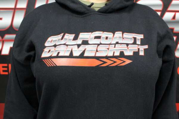 Black hoodie displaying the "Gulf Coast Driveshaft" logo in bold white and orange text, featuring an arrow design.