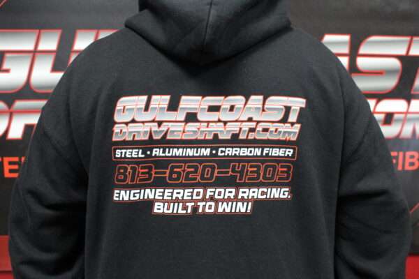 Black hoodie featuring the Gulf Coast Driveshaft logo and text promoting their products, designed for racing enthusiasts.